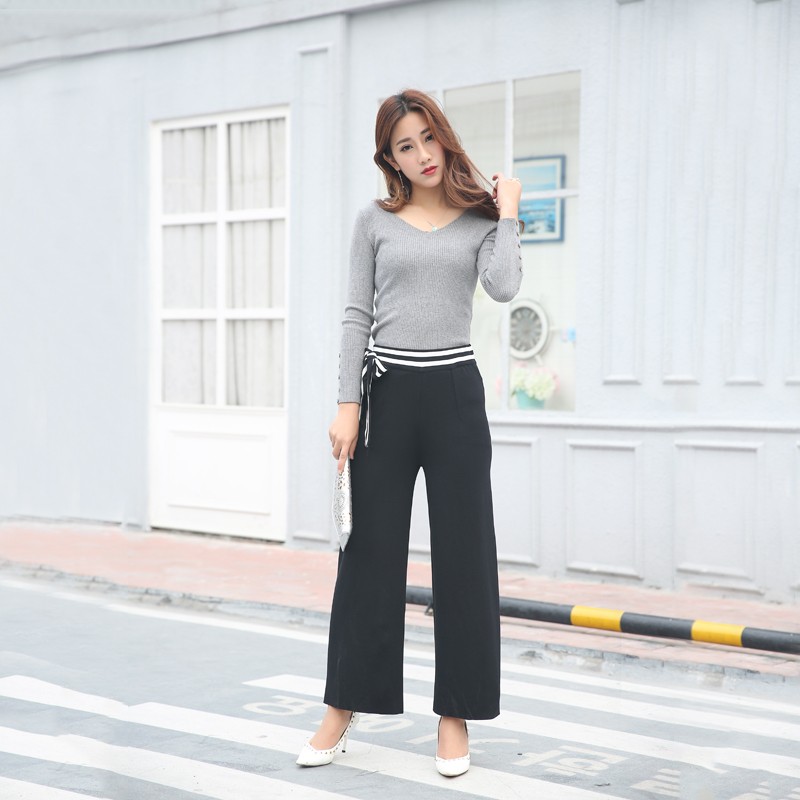 Bows adorn black wide-legged pants